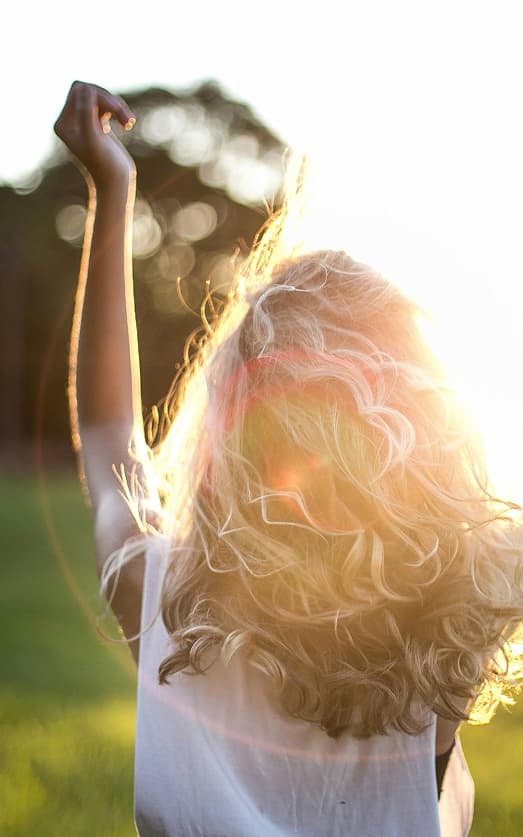 Woman dancing in sunshine